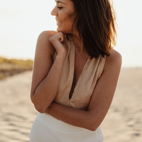 Harlow Smiling resident on a beach at sunset
